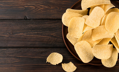 .chips in a plate on a wooden background