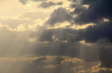 Naklejka na ściany i meble Spiritual Cloudscape Light rays streaking down across dark clouds like God's voice from heaven.