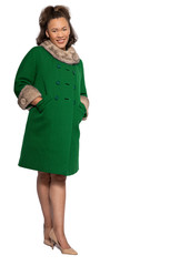 Young light skin black girl in green coat in fashion shoot