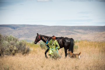 Native American Indian Girl walking with her horse