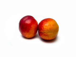 Two nectarines isolated on white background.