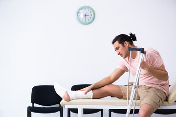 Young injured man waiting for his turn in hospital hall