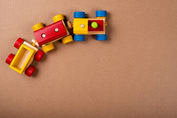 Obraz premium Wooden train on brown background with space for text.
