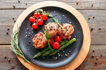 Restaurant food. Grilled pork dish with fresh vegetables. Medallions with herbs and spices.
