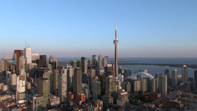 Toronto, Canada, aerial view of Toronto cityscape showing architectural landmark CN Tower and downtown buildings at sunset.