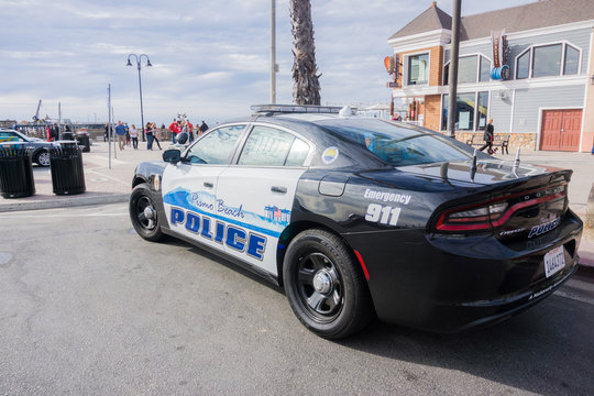 December 24, 2017 Pismo Beach / CA / USA - Custom panted police car parked close to the beach