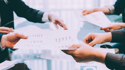 Teamwork and cooperation. Business people working with graphs.