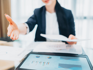 Successful job interview. Female recruiter holding out hand in welcoming gesture.