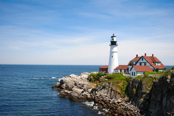 Fototapeta na wymiar Beautiful lighthouse on the rocks of New England