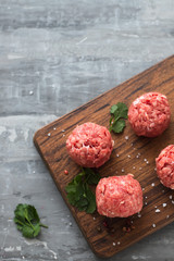 raw meatballs with pepper and salt in plastic box