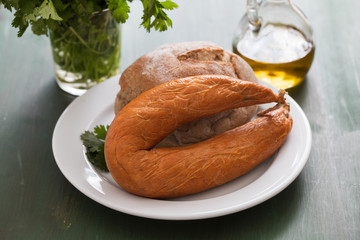 typical portuguese sausage Farinheira with bread on white plate  on ceramic background