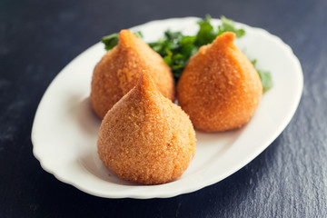 coxinha de frango, typical brazilian chicken croquette on white dish