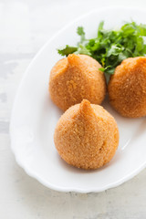 coxinha de frango, typical brazilian chicken croquette on white dish
