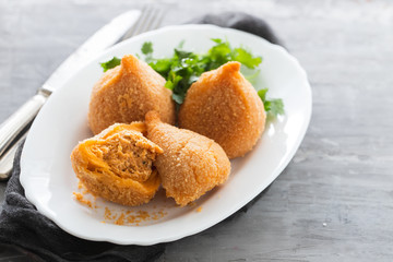 coxinha de frango, typical brazilian chicken croquette on white dish