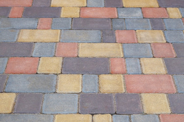 Multicolor Paving stone, background. Pedestrian zone in the park in daylight. Urban varicoloured walkway.