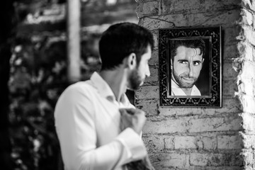 Man looks in the mirror.