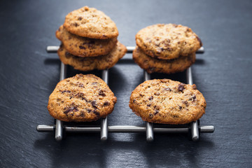 oat cookies with chocolate on ceramic background
