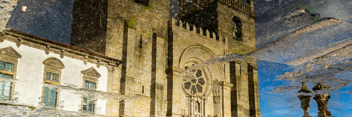 Reflexion of the catholic church in puddle