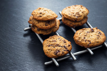 oat cookies with chocolate on ceramic background