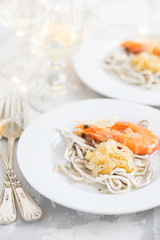 Traditional Spanish food. Gulas with oil and shrimp on white plate.