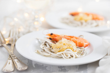 Traditional Spanish food. Gulas with oil and shrimp on white plate.
