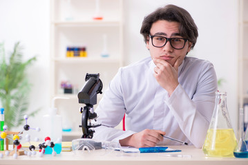 Young male biochemist working in the lab