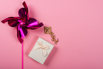 Pink Pinwheel on pink background. Space for text on the right side of the image.