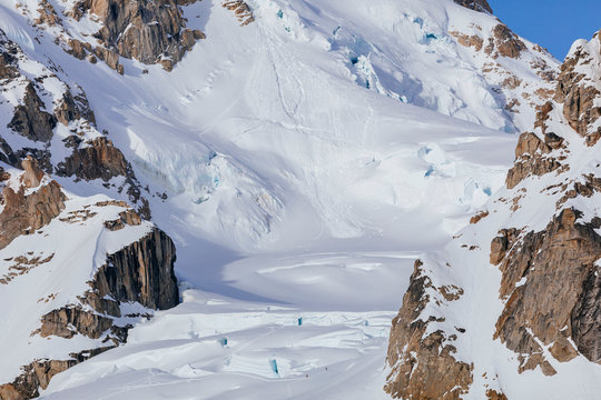 The tiny figures of two climbers on a glacier in the Alaska Range of mountains, Denali National Park, USA.