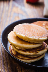 Cooking pancakes with fresh summer strawberries