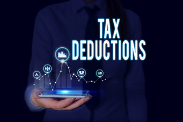 Text sign showing Tax Deductions. Business photo text an amount or cost that subtracted from someone s is income Woman wear formal work suit presenting presentation using smart device