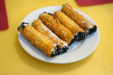 Eating vegan cannoli Italian pastries filled with sweet cream
