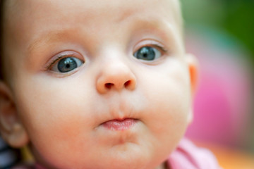 Baby portrait. Closeup face with bright blue eyes. Adorable baby