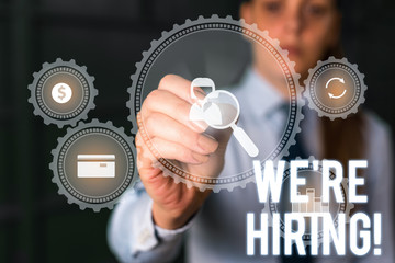 Word writing text We Re Hiring. Business photo showcasing recently employ someone or pay someone to do particular job Woman wear formal work suit presenting presentation using smart device