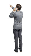 back view of pointing business man in suit talking on mobile phone.