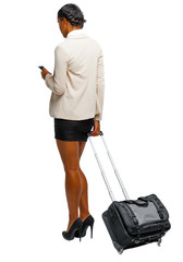 Back view of a black African-American in formal attire with a suitcase with smartphone.