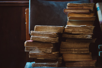 stack of old books on wooden table