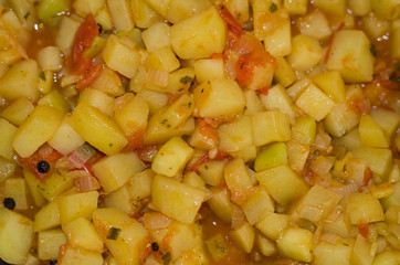 Orange vegetable ragout with potato, zucchini and tomato