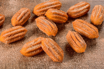 Dulce de leche churro on wooden background
