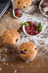 Delicious flavored cupcake with raspberries, white cream, and chocolate icing.