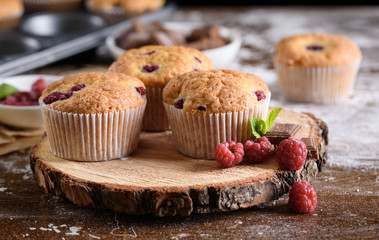 Delicious flavored cupcake with raspberries, white cream, and chocolate icing.
