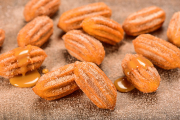 Dulce de leche churro on wooden background