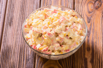 Salad with crab sticks , corn , eggs and mayonnaise