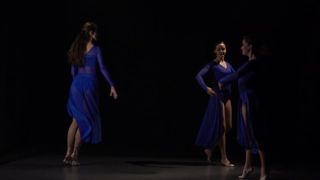 Ballerinas jumping runs up in circle of studio. Slow motion
