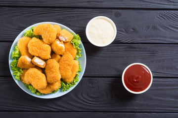 Chicken nuggets in plate on rustic background