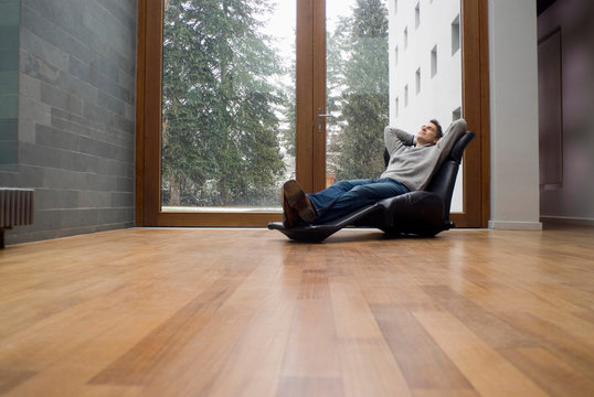 Man relaxing in armchair