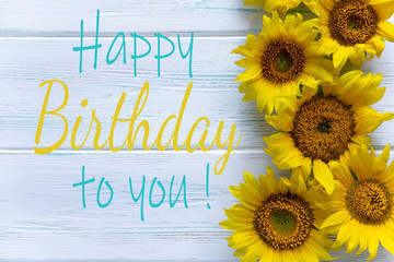 Happy Birthday. Greeting card with flowers for a girl, mom's birthday. View from above. Sunflower...