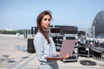Installation of stage equipment and preparing for a live concert open air. Event manager portrait....