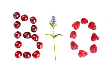Letter BIO fresh cherry raspberry nad mint flower flat lay