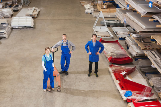 Germany, Neukirch, Instructor and apprentices standing in industrial hall, elevated view