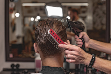 Barber does hair styling. Men's Hair Care.